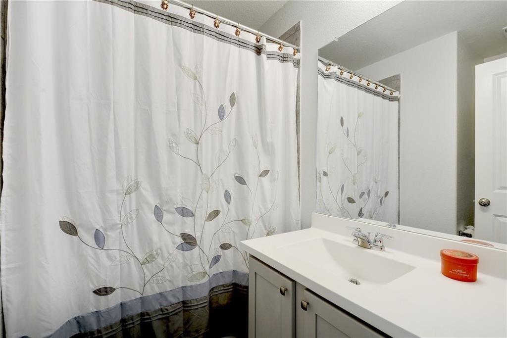 6813 Colorado Bluffs Road Austin, TX 78744 - Photo 14 of 20 Full bathroom with vanity and a shower with curtain