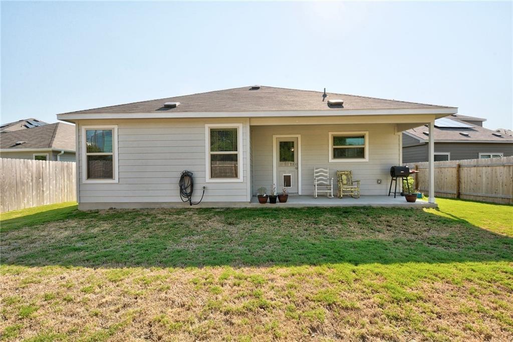 6813 Colorado Bluffs Road Austin, TX 78744 - Photo 15 of 20 Back of house with a fenced backyard and a patio
