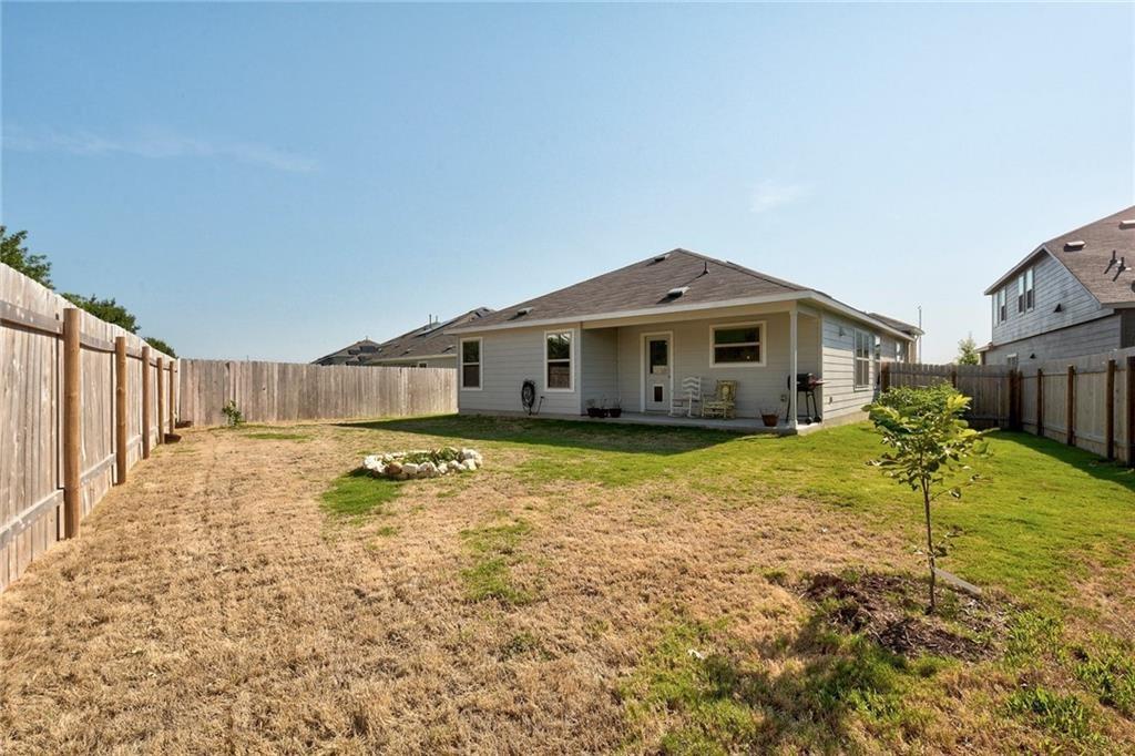 6813 Colorado Bluffs Road Austin, TX 78744 - Photo 16 of 20 Rear view of house featuring a fenced backyard and a patio area