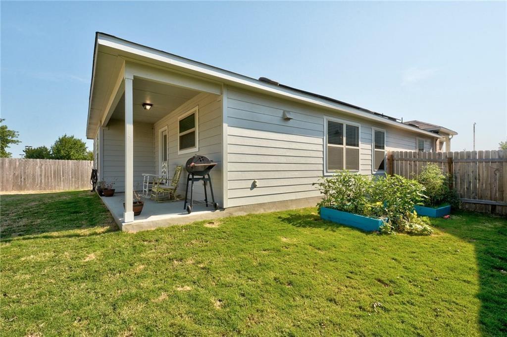 6813 Colorado Bluffs Road Austin, TX 78744 - Photo 17 of 20 Back of property featuring a fenced backyard and a patio