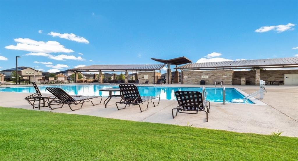 6813 Colorado Bluffs Road Austin, TX 78744 - Photo 19 of 20 Community pool with a patio area and a lawn