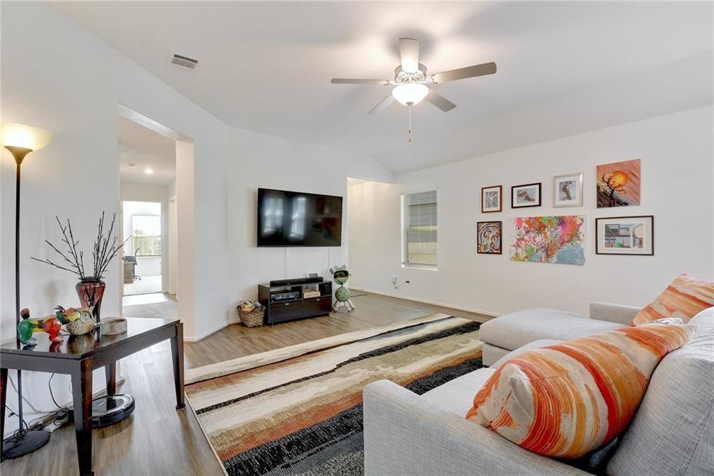 6813 Colorado Bluffs Road Austin, TX 78744 - Photo 2 of 20 Living area featuring wood finished floors and a ceiling fan