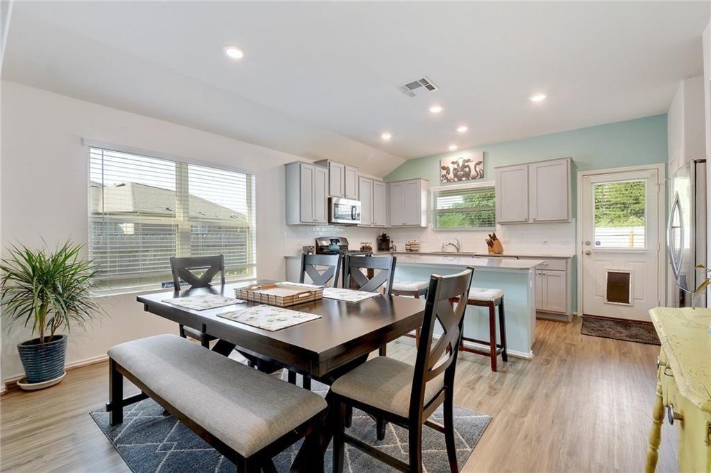 6813 Colorado Bluffs Road Austin, TX 78744 - Photo 6 of 20 Dining area featuring light wood-style flooring, plenty of natural light, recessed lighting, and lofted ceiling