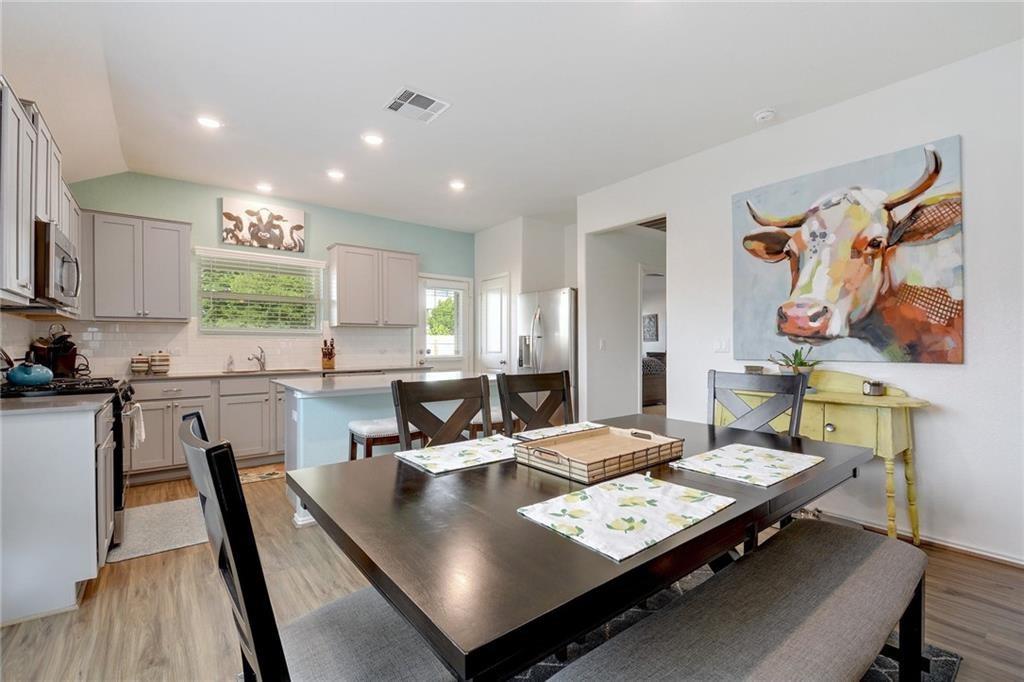 6813 Colorado Bluffs Road Austin, TX 78744 - Photo 7 of 20 Dining room with light wood-type flooring, recessed lighting, and lofted ceiling