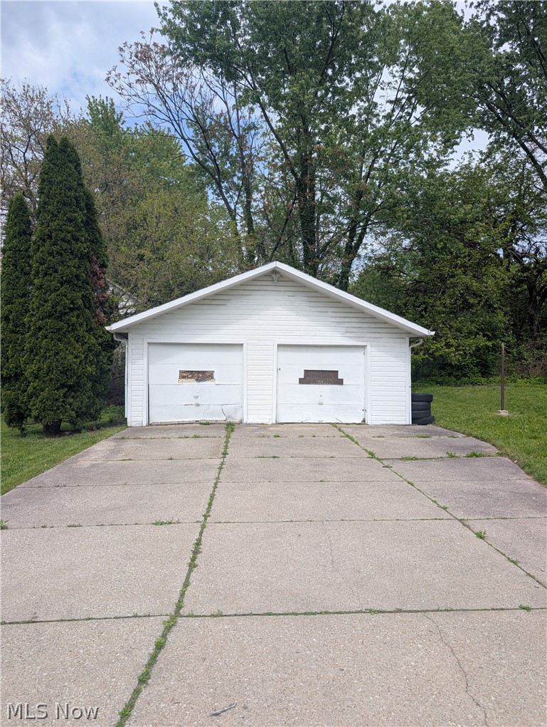 7515 Ottawa Road Cleveland, OH 44105 - Photo 5 of 21 Detached two-car garage with white vinyl siding and a gabled roofline