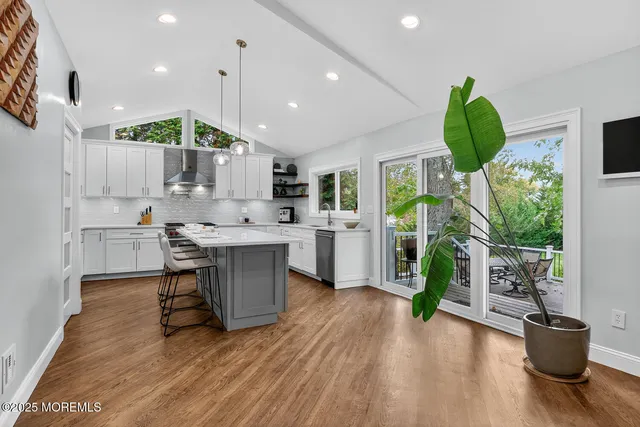 a kitchen with a table chairs and a wooden floor