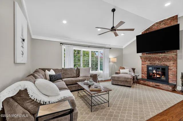 a living room with furniture fireplace and flat screen tv