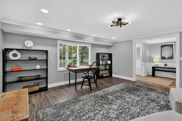 a view of a livingroom with furniture and a flat screen tv