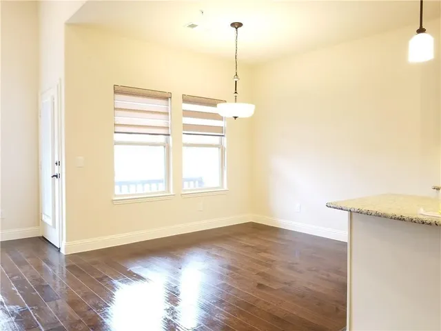 a view of a room with wooden floor and windows