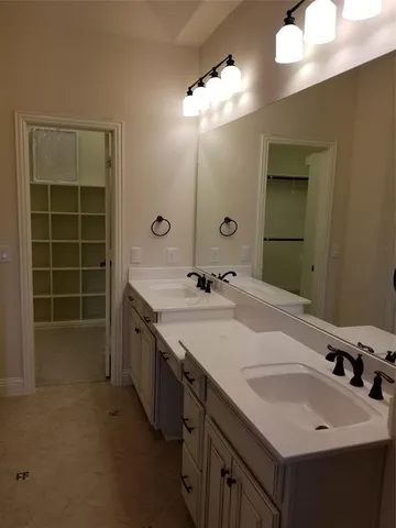 a bathroom with a double vanity sink and a mirror