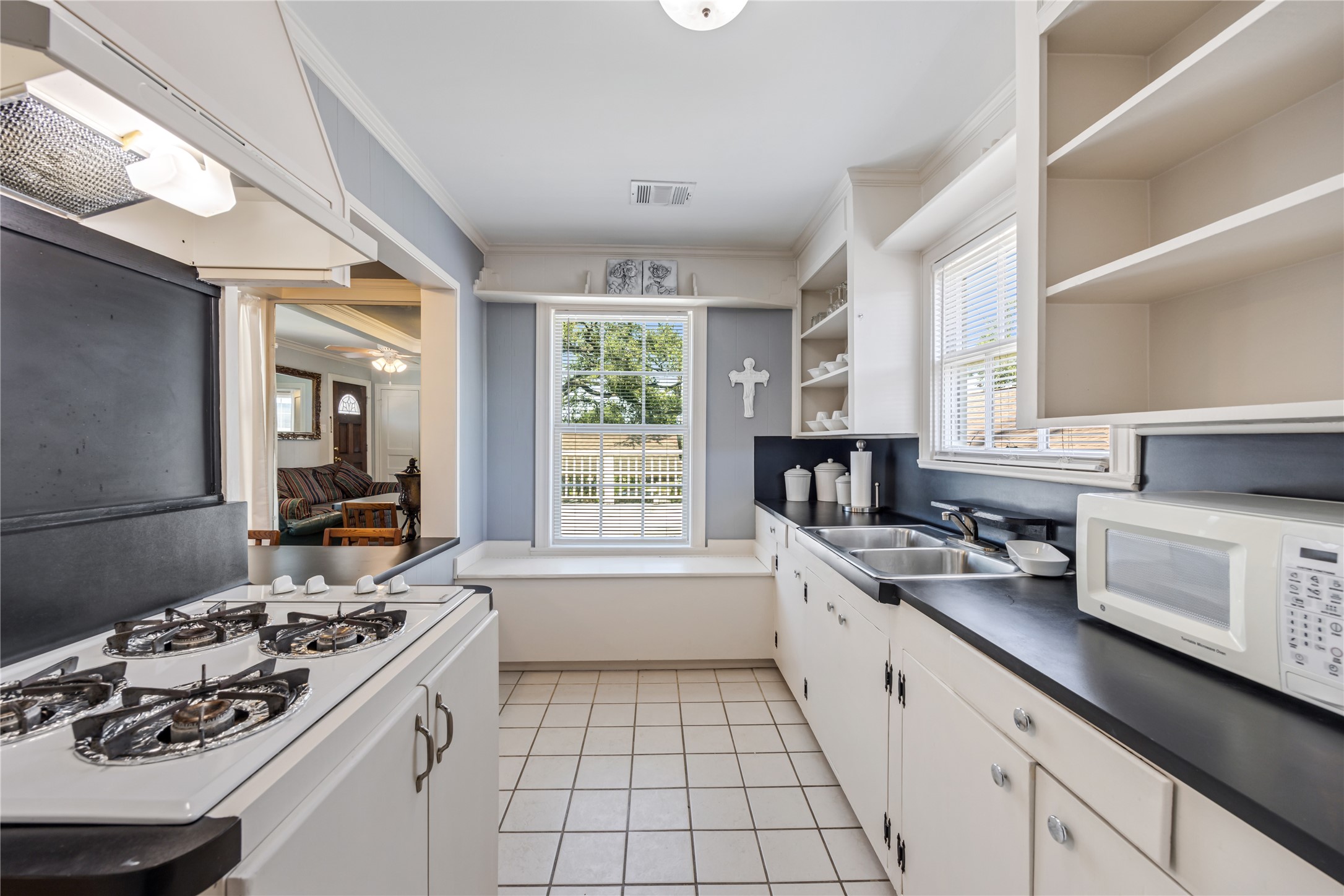 1310 Reid Street, Unit B Houston, TX 77022 - Photo 6 of 13 a kitchen with a sink a stove cabinets and a window