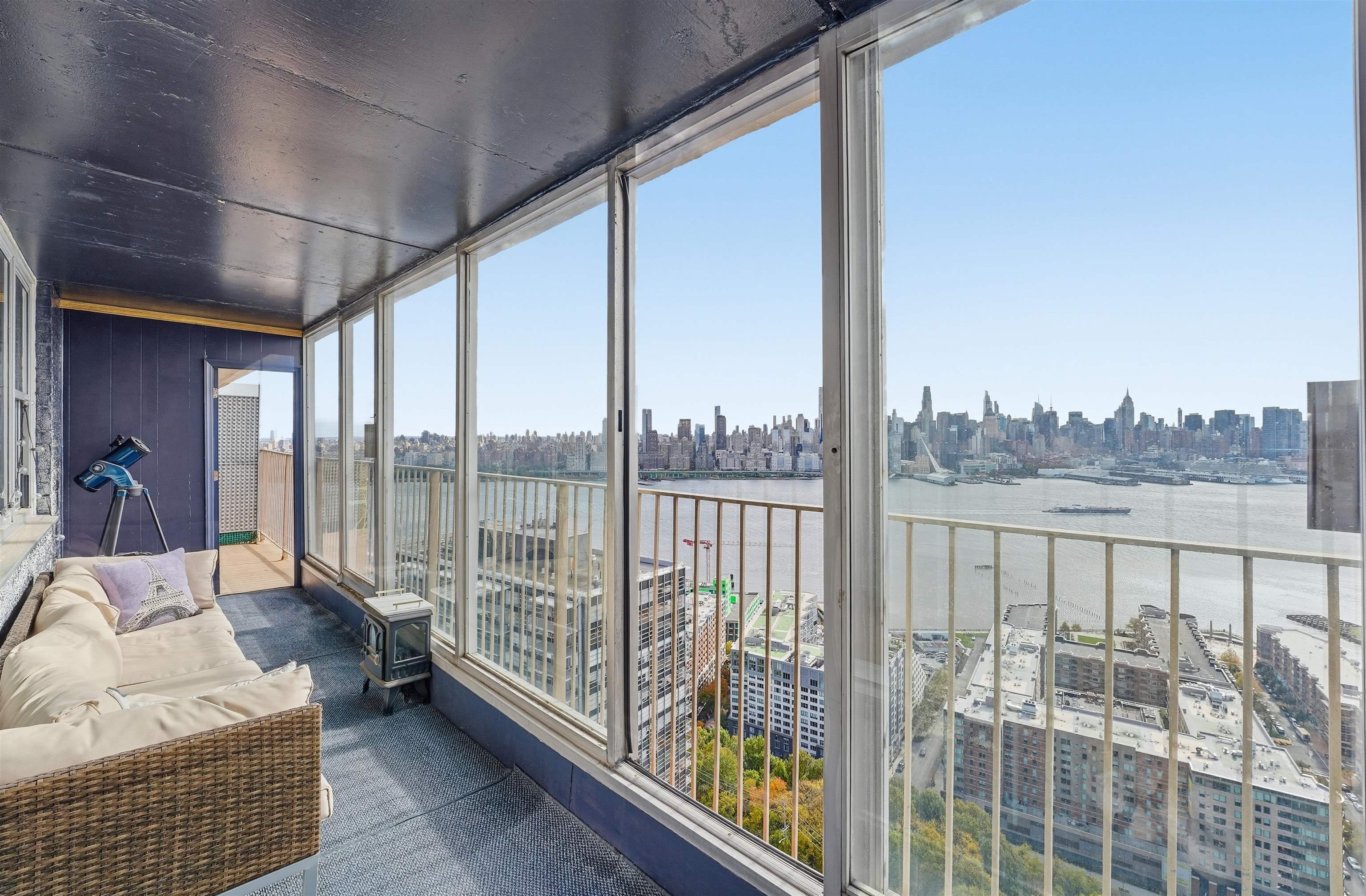 6040 Boulevard East, Unit 32E West New York, NJ 07093 - Photo 11 of 27 a balcony with furniture and city view