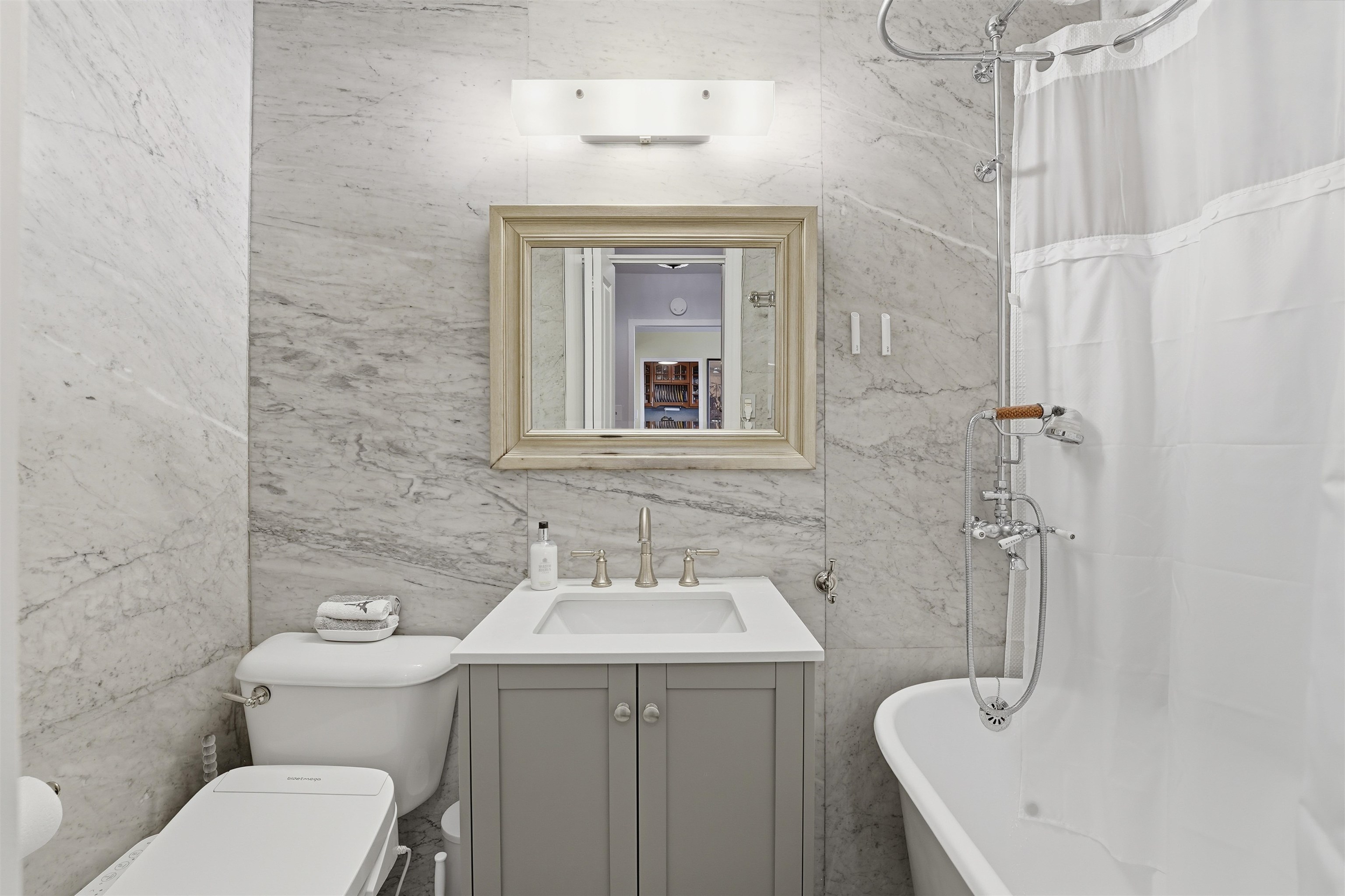 6040 Boulevard East, Unit 32E West New York, NJ 07093 - Photo 15 of 27 a bathroom with a toilet sink and mirror