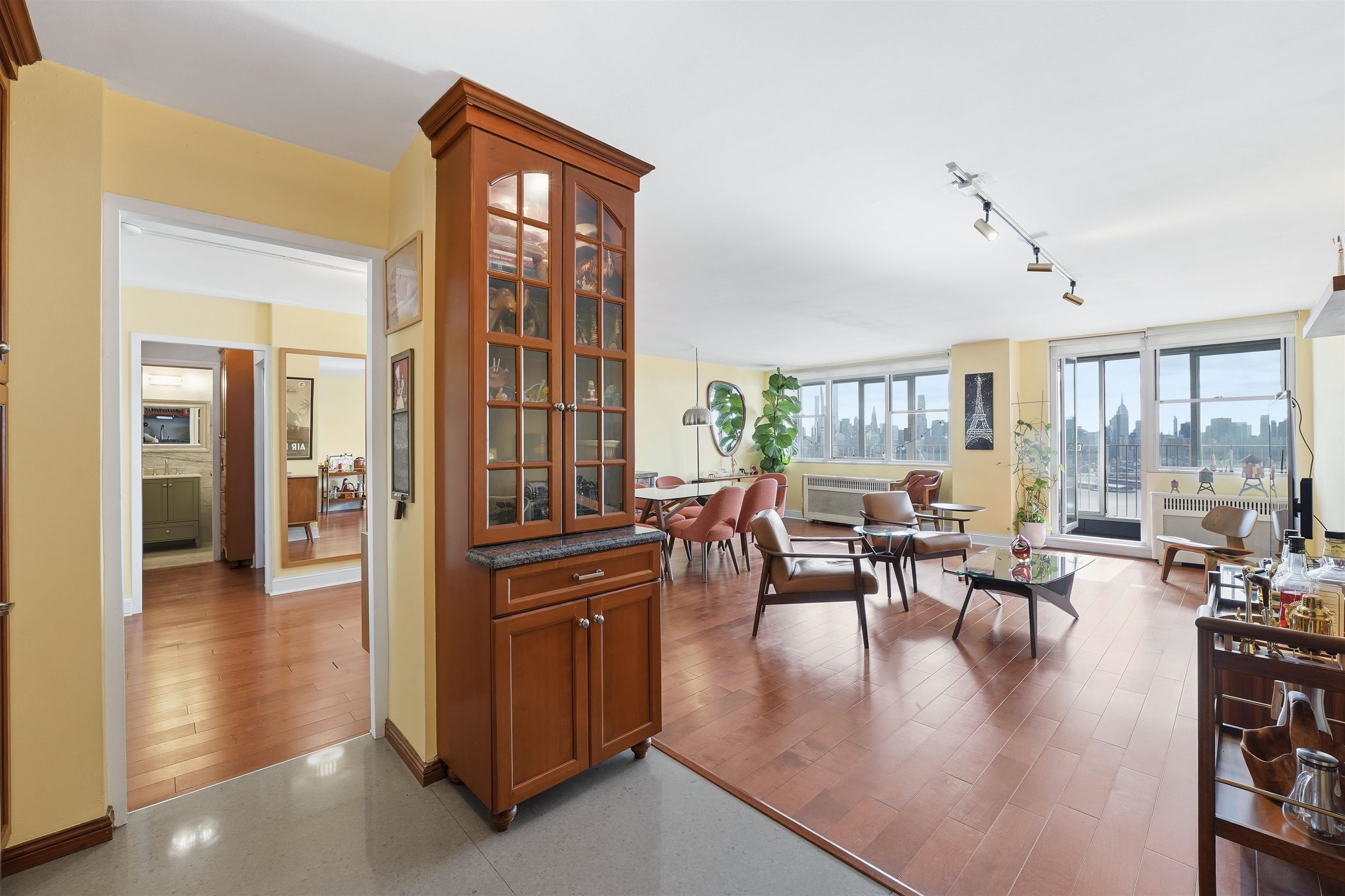 6040 Boulevard East, Unit 32E West New York, NJ 07093 - Photo 6 of 27 a living room with furniture large window and flat screen tv