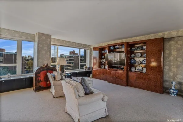 a living room with furniture and a balcony