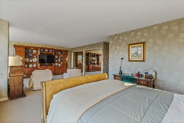 a bedroom with a large bed and a window