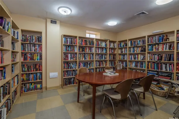 a view of a a dining room with furniture and a bookshelf