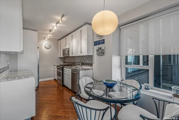 a kitchen with sink cabinets and stainless steel appliances