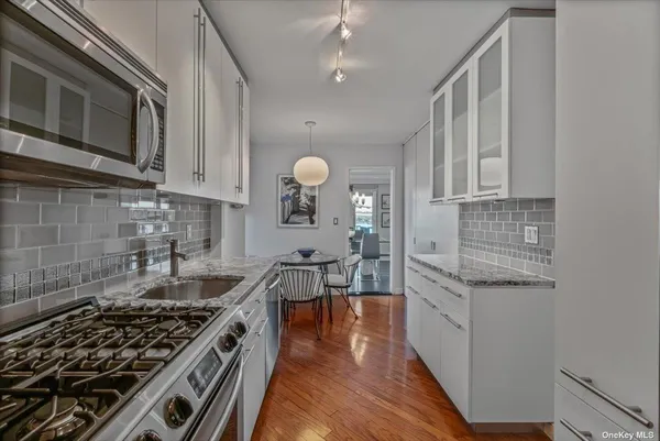 a kitchen with stainless steel appliances granite countertop a stove and a sink