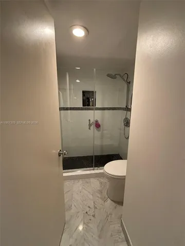 a bathroom with a toilet and a shower