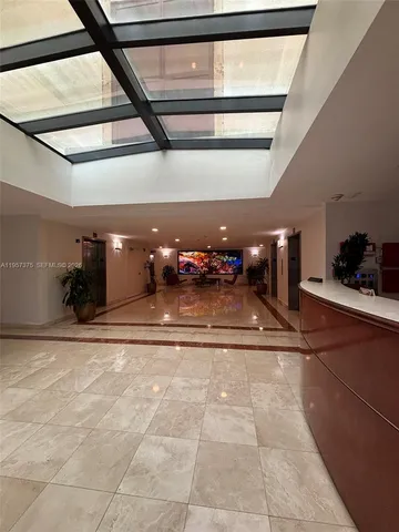 a living room with furniture a chandelier and a fireplace