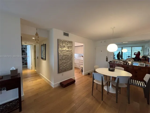 a view of a a dining room with furniture window and wooden floor
