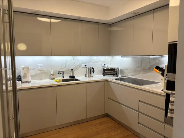 a kitchen with a sink and cabinets