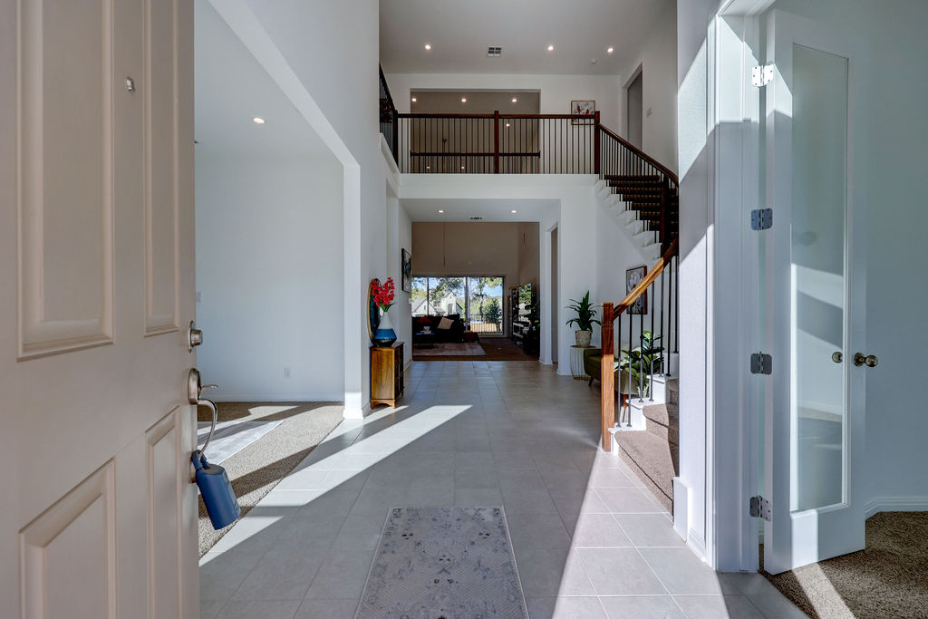 351 Pigeon River Road Kyle, TX 78640 - Photo 4 of 40 Foyer with stairs, a high ceiling, recessed lighting, and light tile patterned flooring