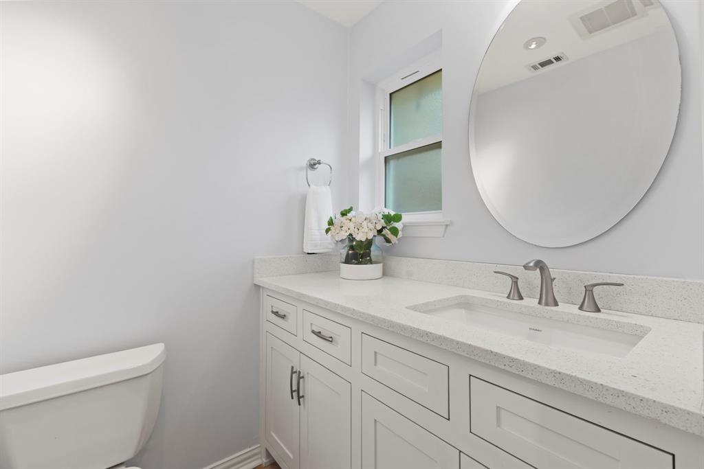 16707 Rustic Meadows Drive Dallas, TX 75248 - Photo 16 of 33 a bathroom with a sink and a mirror