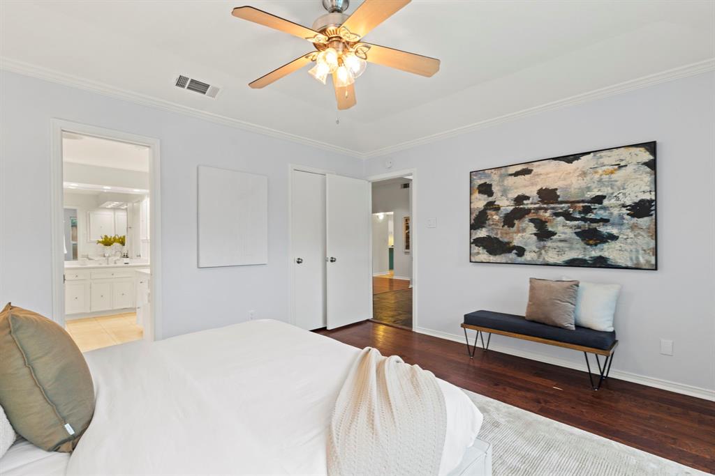 16707 Rustic Meadows Drive Dallas, TX 75248 - Photo 18 of 33 a bedroom with a bed and a chandelier