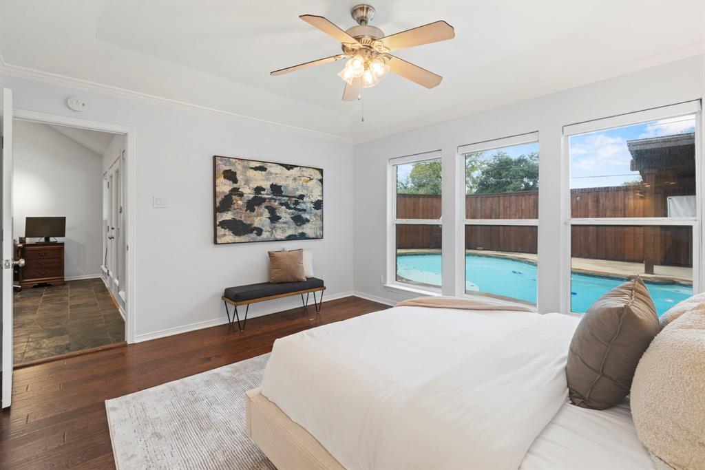 16707 Rustic Meadows Drive Dallas, TX 75248 - Photo 20 of 33 a bedroom with a bed and a large window with wooden floor