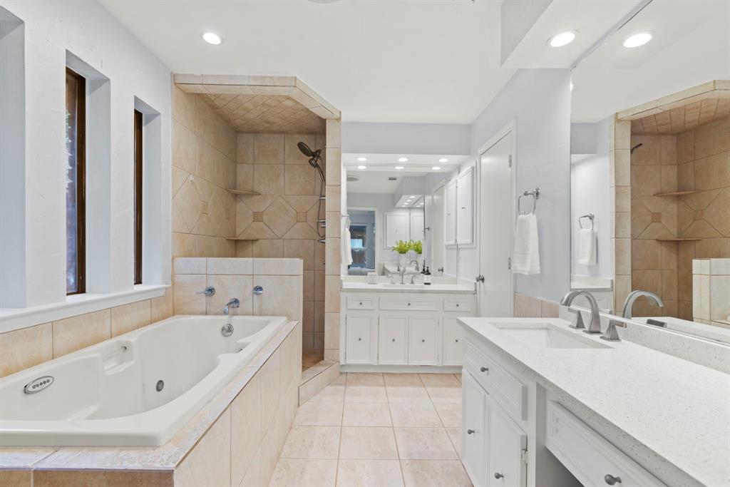 16707 Rustic Meadows Drive Dallas, TX 75248 - Photo 21 of 33 a bathroom with a bathtub a double vanity sink and mirror