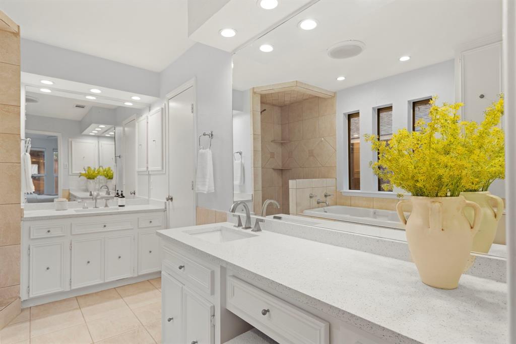 16707 Rustic Meadows Drive Dallas, TX 75248 - Photo 22 of 33 a spacious bathroom with a double vanity sink a mirror and a bathtub