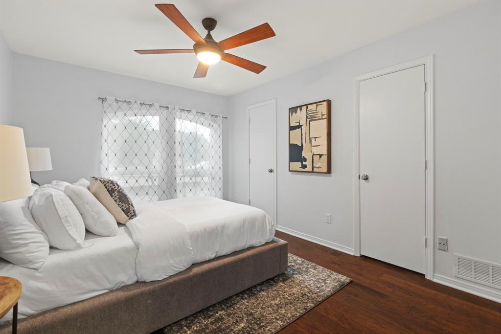 16707 Rustic Meadows Drive Dallas, TX 75248 - Photo 25 of 33 a bedroom with a large bed chandelier and a window