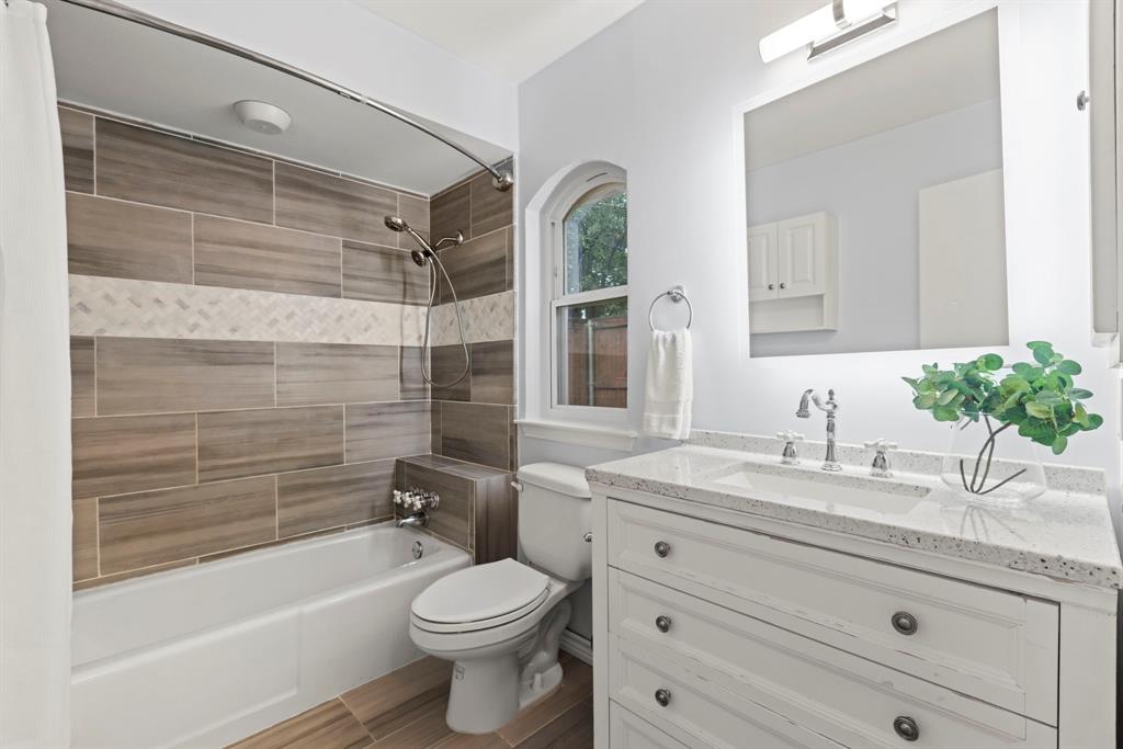 16707 Rustic Meadows Drive Dallas, TX 75248 - Photo 26 of 33 a bathroom with a granite countertop toilet sink and bathtub