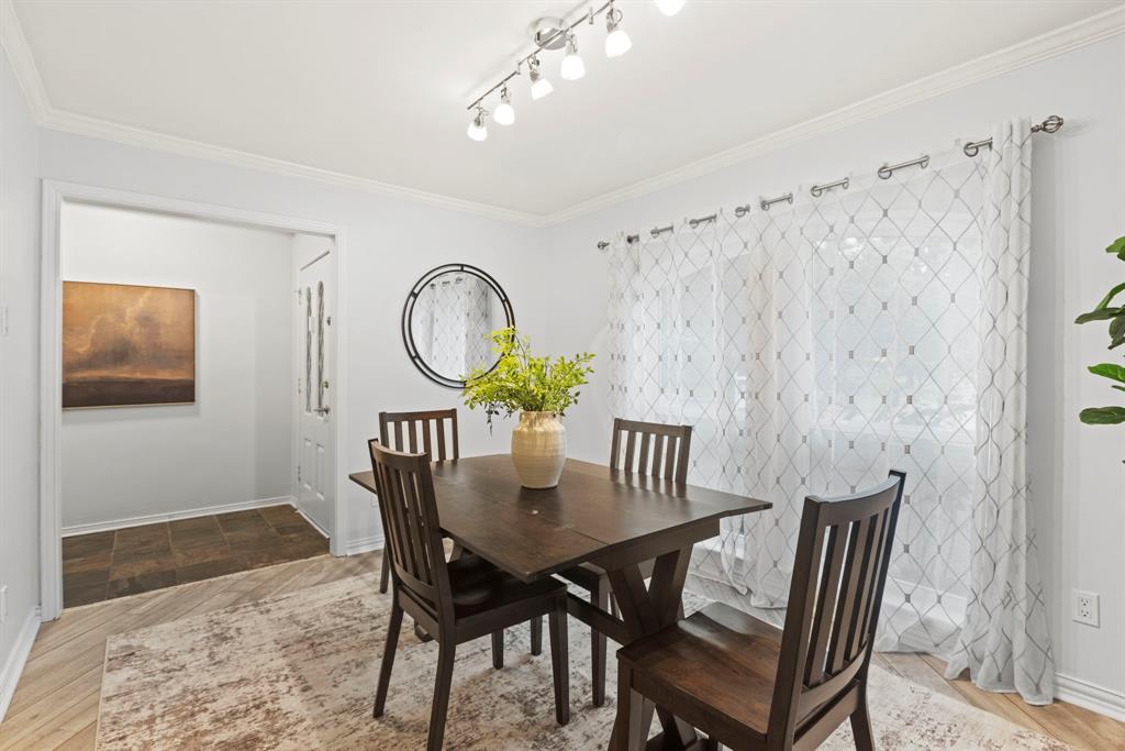 16707 Rustic Meadows Drive Dallas, TX 75248 - Photo 7 of 33 a view of a dining room with furniture and wooden floor