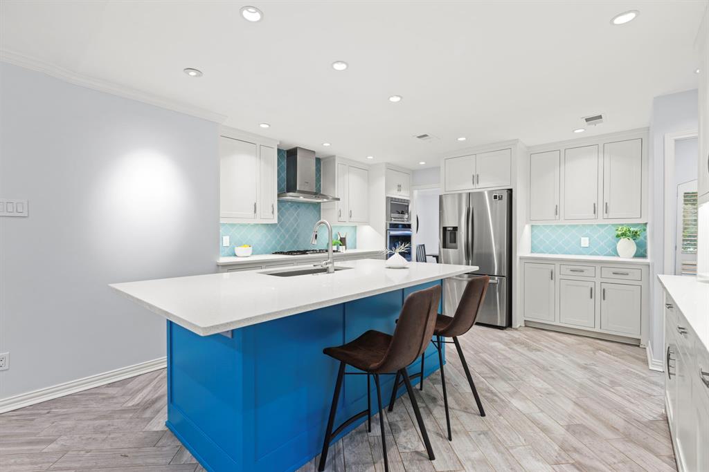 16707 Rustic Meadows Drive Dallas, TX 75248 - Photo 9 of 33 a kitchen with refrigerator cabinets and wooden floor