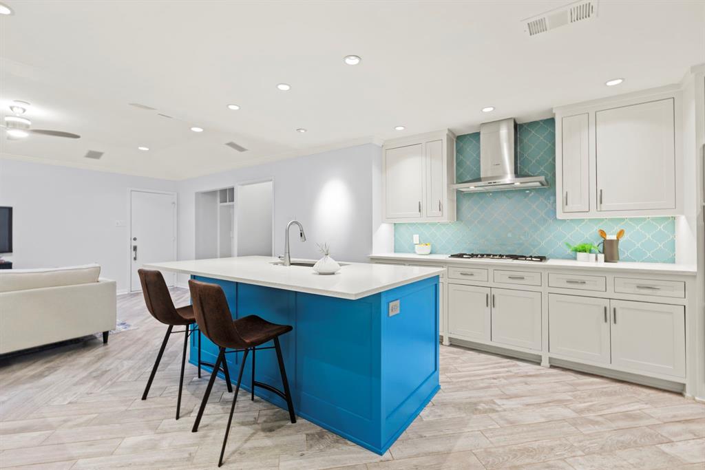 16707 Rustic Meadows Drive Dallas, TX 75248 - Photo 10 of 33 a kitchen with a sink and chairs
