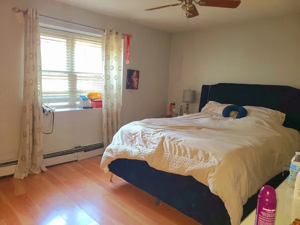 a bedroom with a bed and window