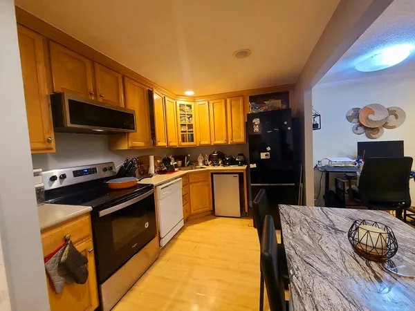 a kitchen with a stove a sink and a microwave