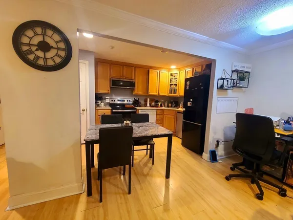 a view of a dining room with furniture and a window