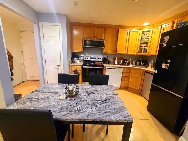 a kitchen with granite countertop wooden cabinets and stainless steel appliances