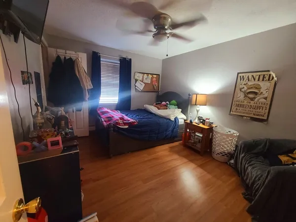 a bedroom with furniture and a closet