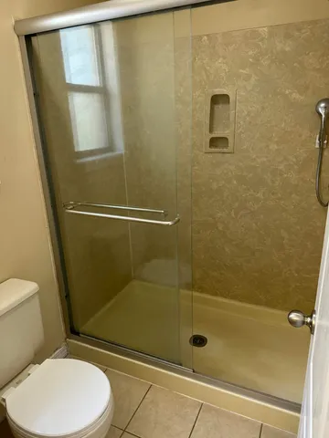 a bathroom with a toilet and shower