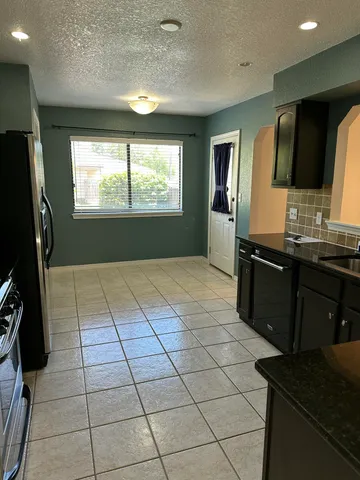 a kitchen with stainless steel appliances a sink stove and refrigerator