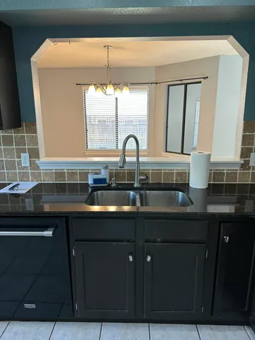 a kitchen with a sink and cabinets