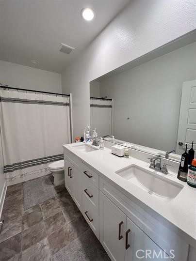 24800 Cimarron Circle Menifee, CA 92584 - Photo 14 of 29 a bathroom with a double vanity sink and mirror