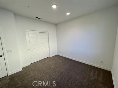 24800 Cimarron Circle Menifee, CA 92584 - Photo 15 of 29 an empty room with a door