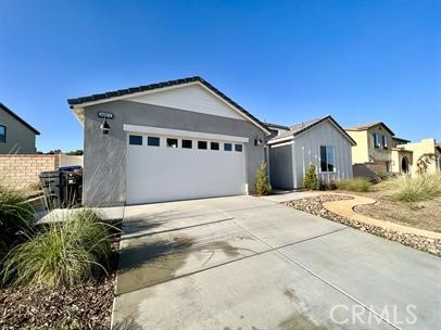 24800 Cimarron Circle Menifee, CA 92584 - Photo 2 of 29 a front view of a house with a yard and garage