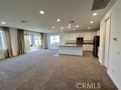 24800 Cimarron Circle Menifee, CA 92584 - Photo 4 of 29 a view of a kitchen with a sink and refrigerator